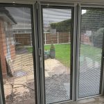 bifold door installation inside view looking into garden - belfry Windows