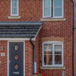 front view of home with newly installed door and windows - belfry Windows