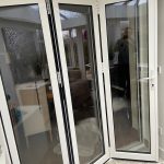 white bifold door installation for client- belfry Windows